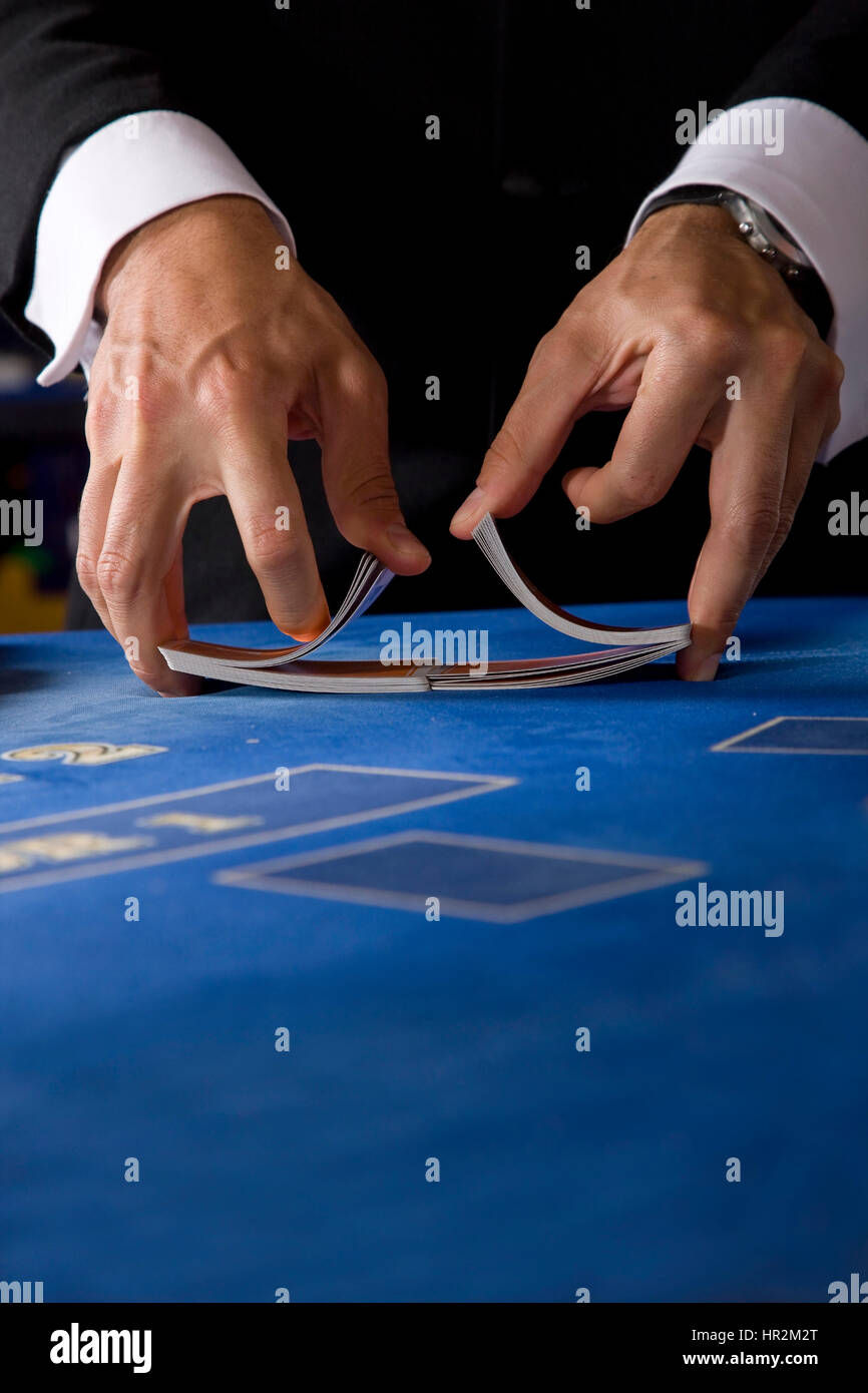 Two hands shuffling a deck of cards in a casino Stock Photo Alamy