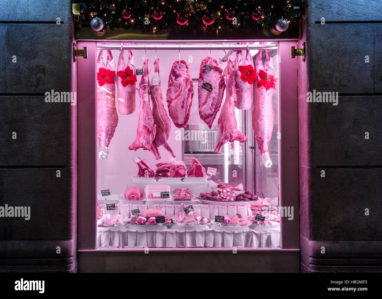 Barcelona, Spain, December 21, 2016. Butcher's store window with quartered pork and other pieces of farm animals. Stock Photo