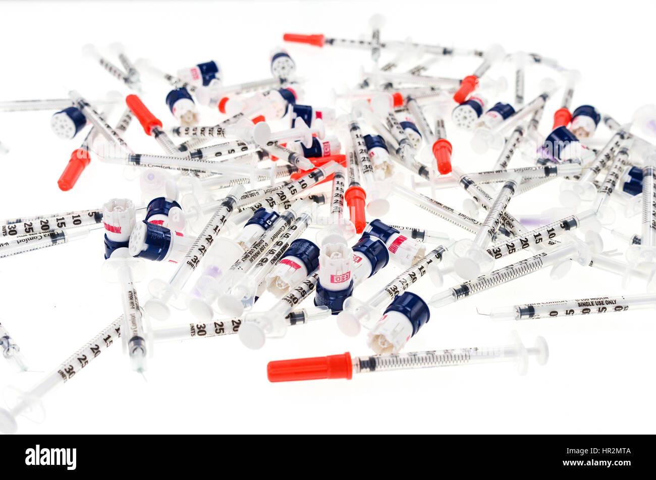 Insulin syringes and lancets on a white background Stock Photo