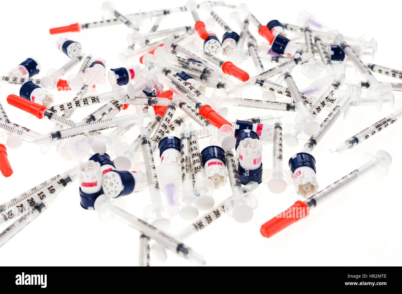 Insulin syringes and lancets on a white background Stock Photo