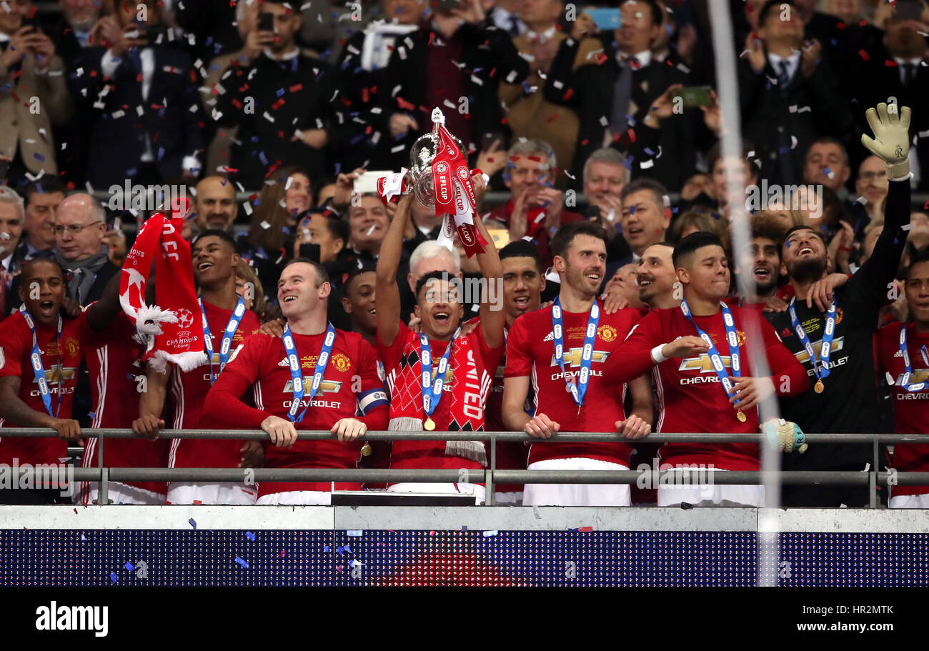 Manchester United's Jesse Lingard lifts the trophy after the EFL Cup Final at Wembley Stadium, London. Stock Photo