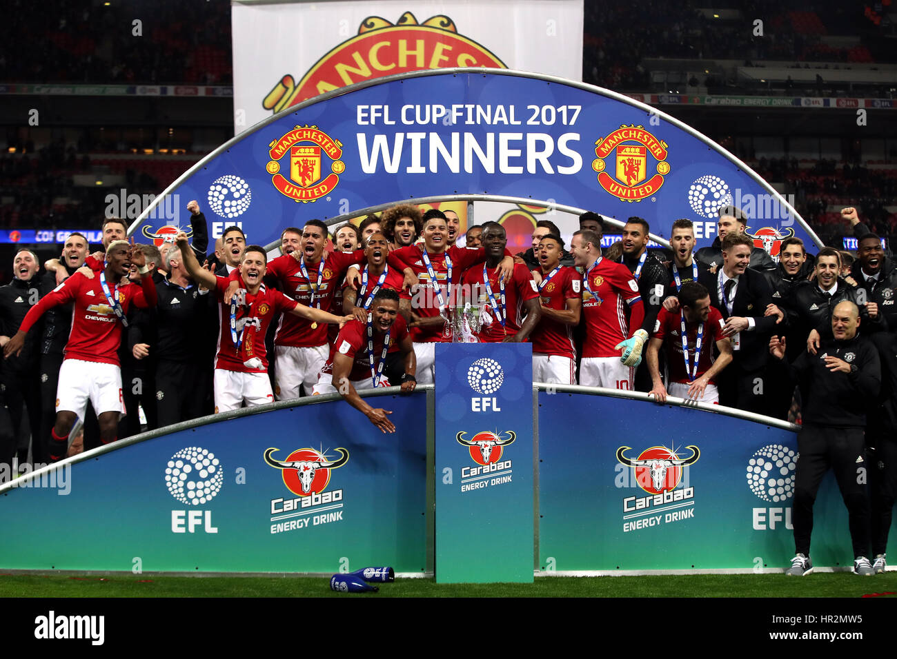 Manchester United players celebrate with the trophy after the EFL Cup Final at Wembley Stadium, London. Stock Photo