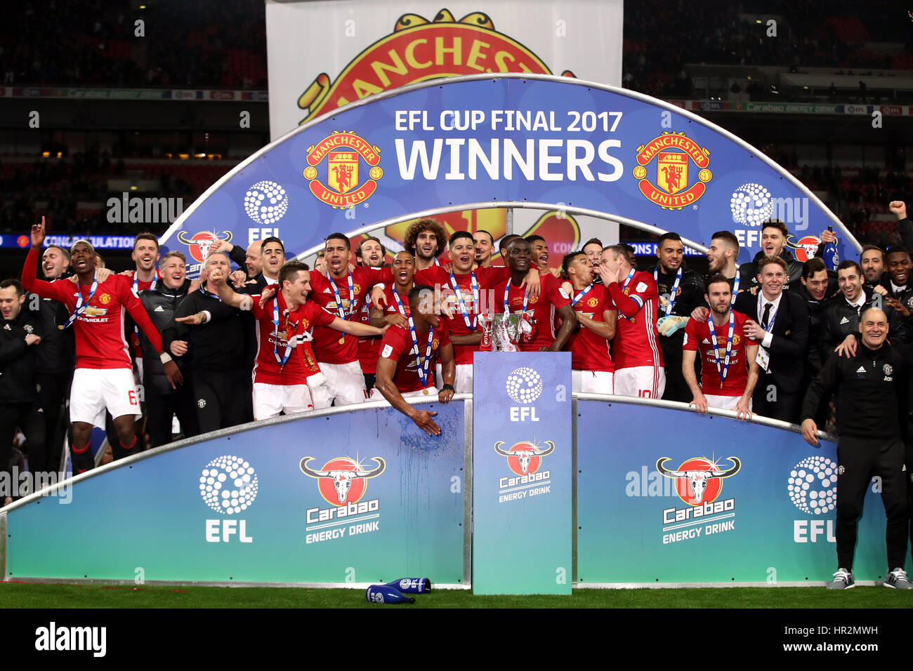 Manchester United players celebrate with the trophy after the EFL Cup