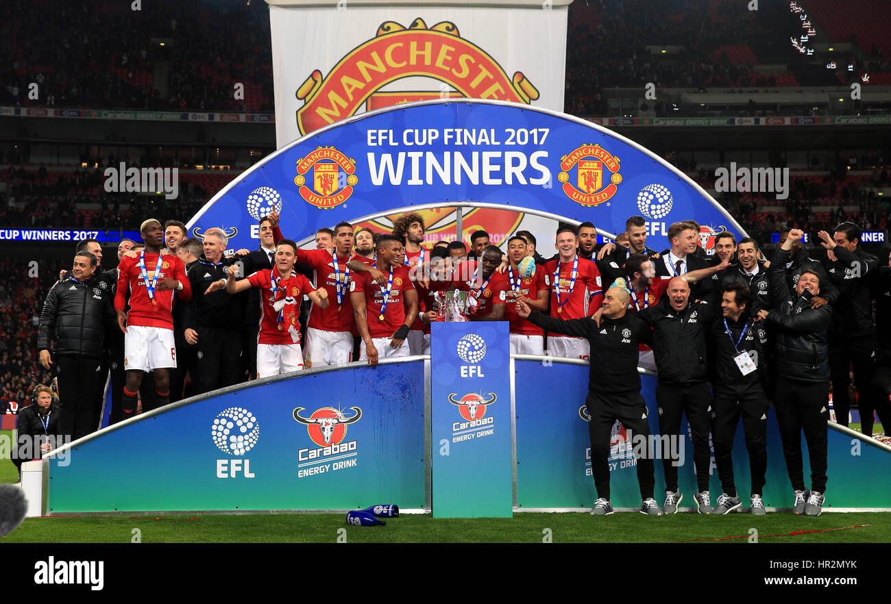 Manchester United players celebrate with the trophy after the EFL Cup