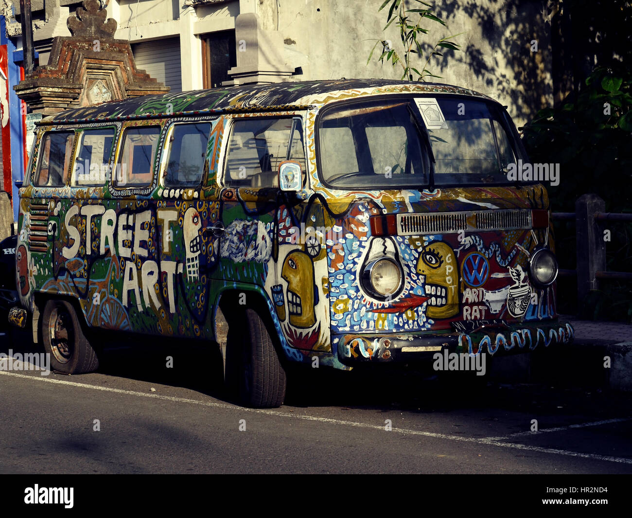 Old painted VW Kombi bus on a street of Ubud town. Bali, Indonesia Stock Photo