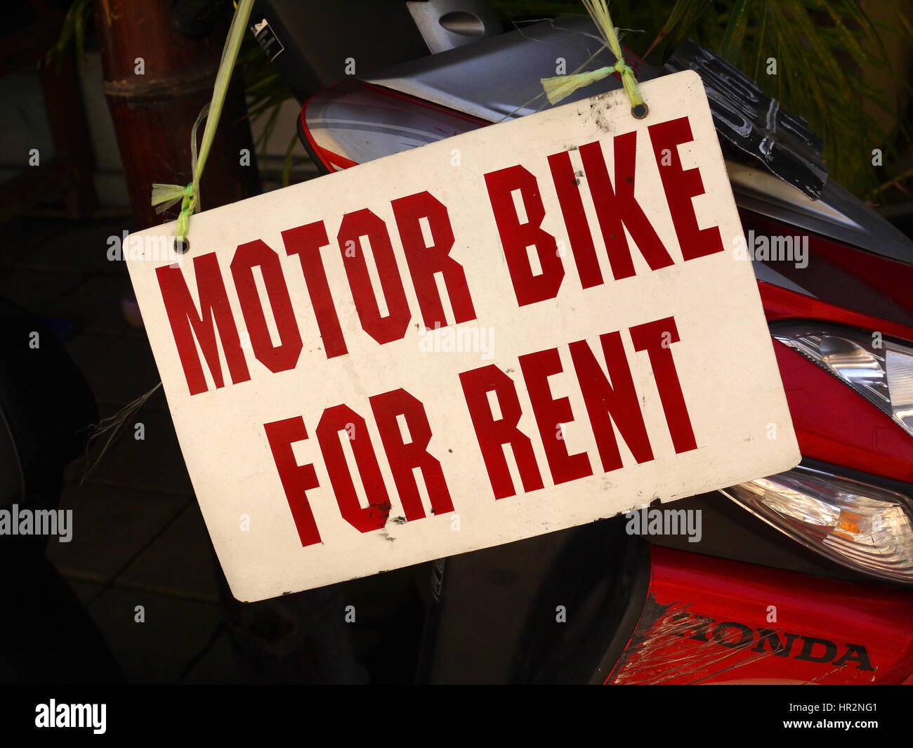 'Motor bike for rent' sign over Honda motorbike. Kuta, Bali, Indonesia Stock Photo