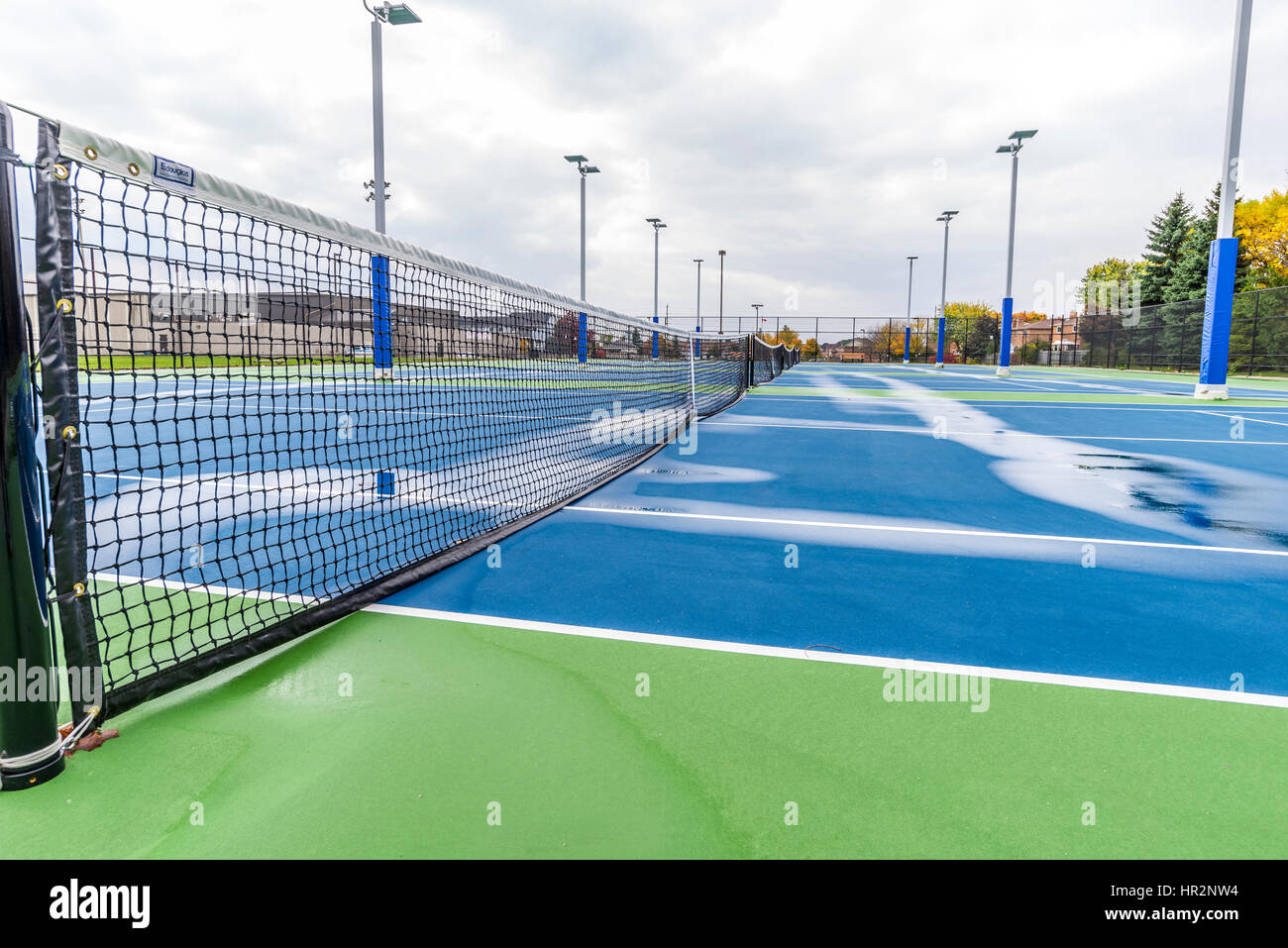 Looking down the nets across the many tennis courts wet after a rain shower in Stouffville Ontario Canada. Stock Photo