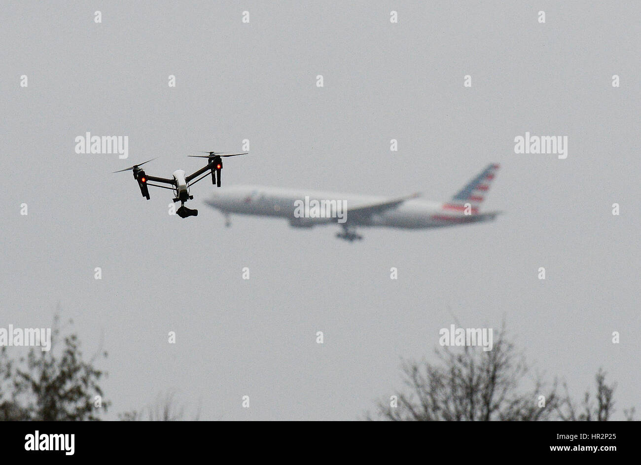 A drone flies in Hanworth Park in west London, as a British Airways 747 plane prepares to land at Heathrow Airport behind. Stock Photo