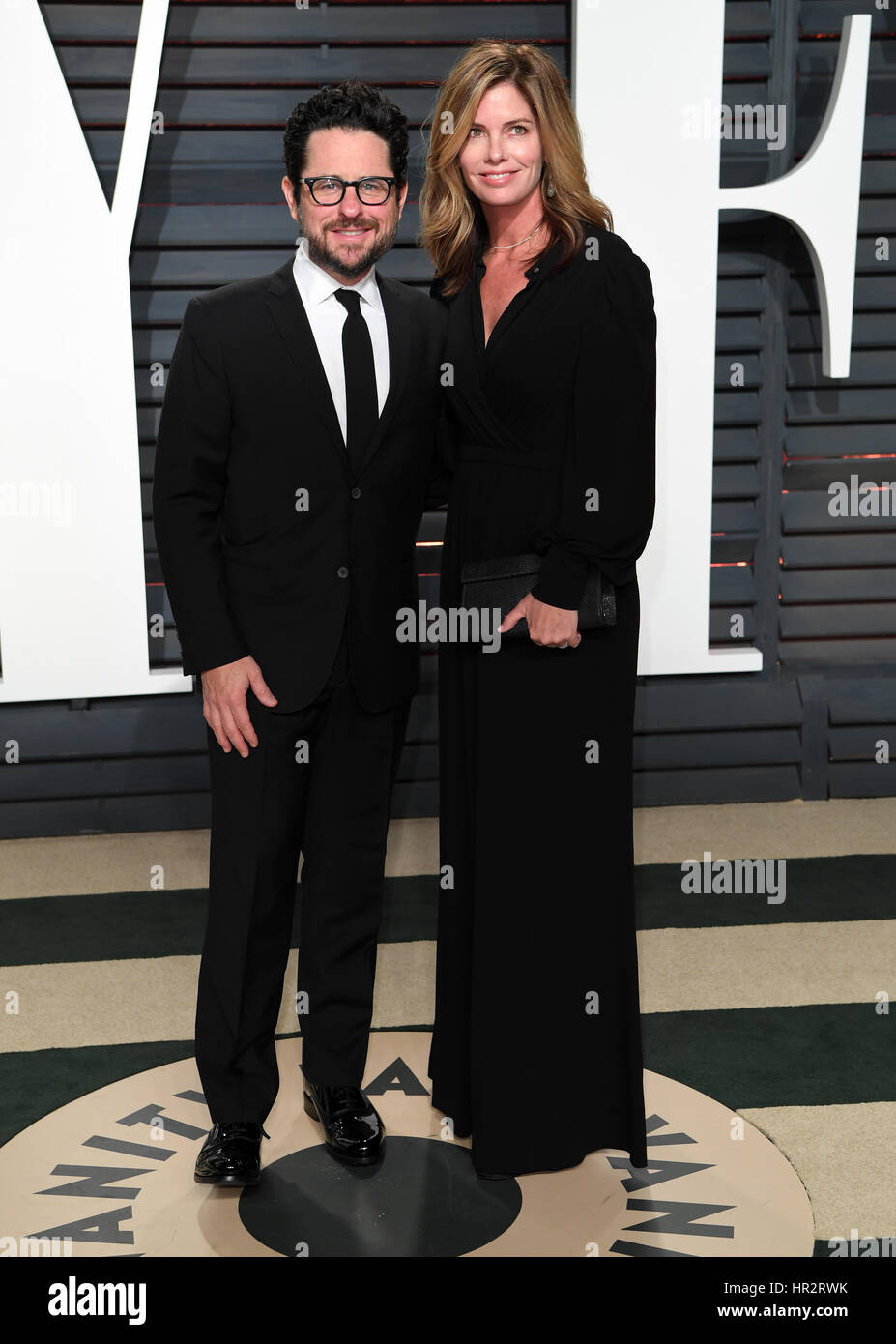 Director J.J. Abrams (L) and Katie McGrath arriving at the Vanity Fair Oscar Party in Beverly Hills, Los Angeles, USA. Stock Photo