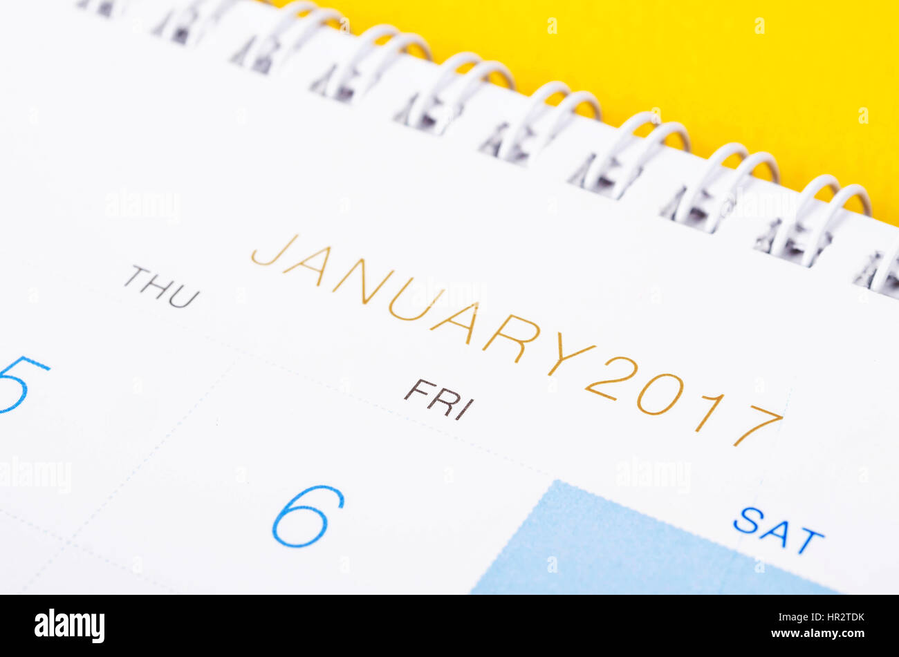 Desk top calendar January 2017 close up on yellow background. Stock Photo
