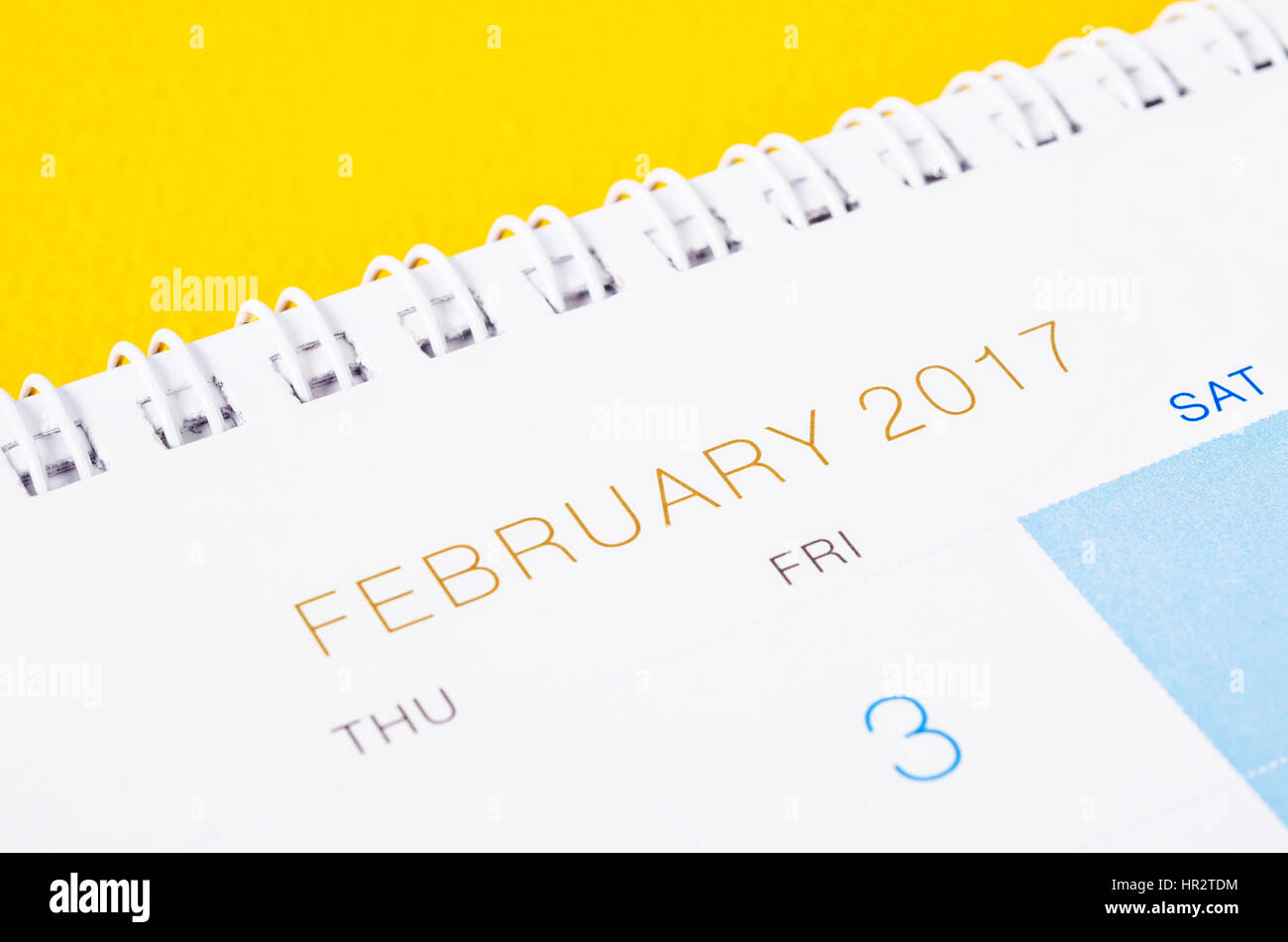 Desk top calendar February 2017 close up on yellow background. Stock Photo