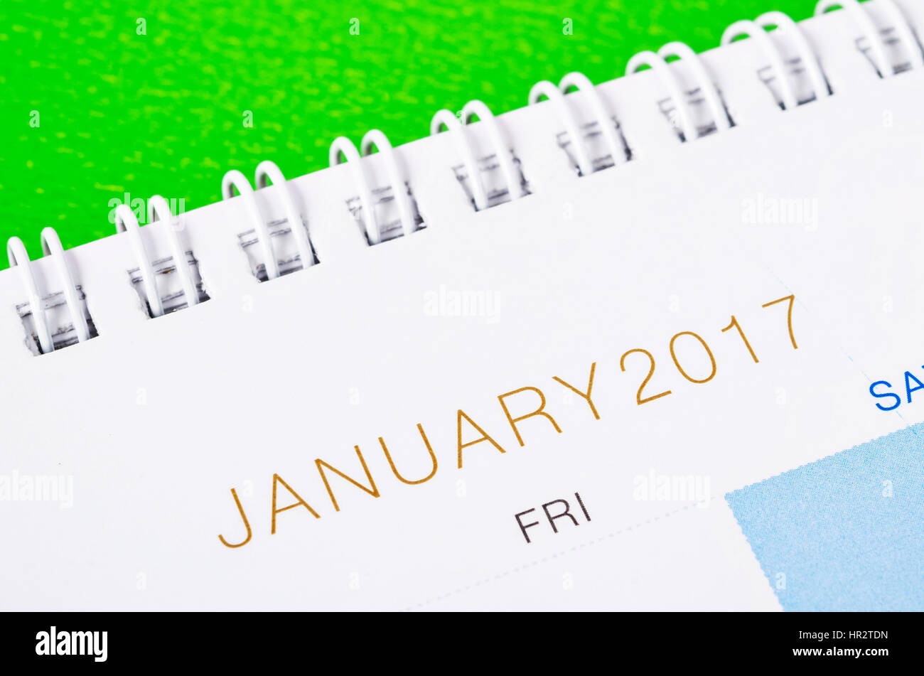 Desk top calendar January 2017 close up on green background. Stock Photo