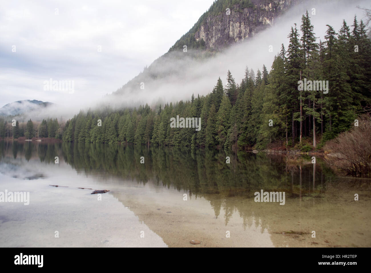 Mist hangs over Davis Lake Provincial Park at dawn, near the town of Mission, British Columbia
