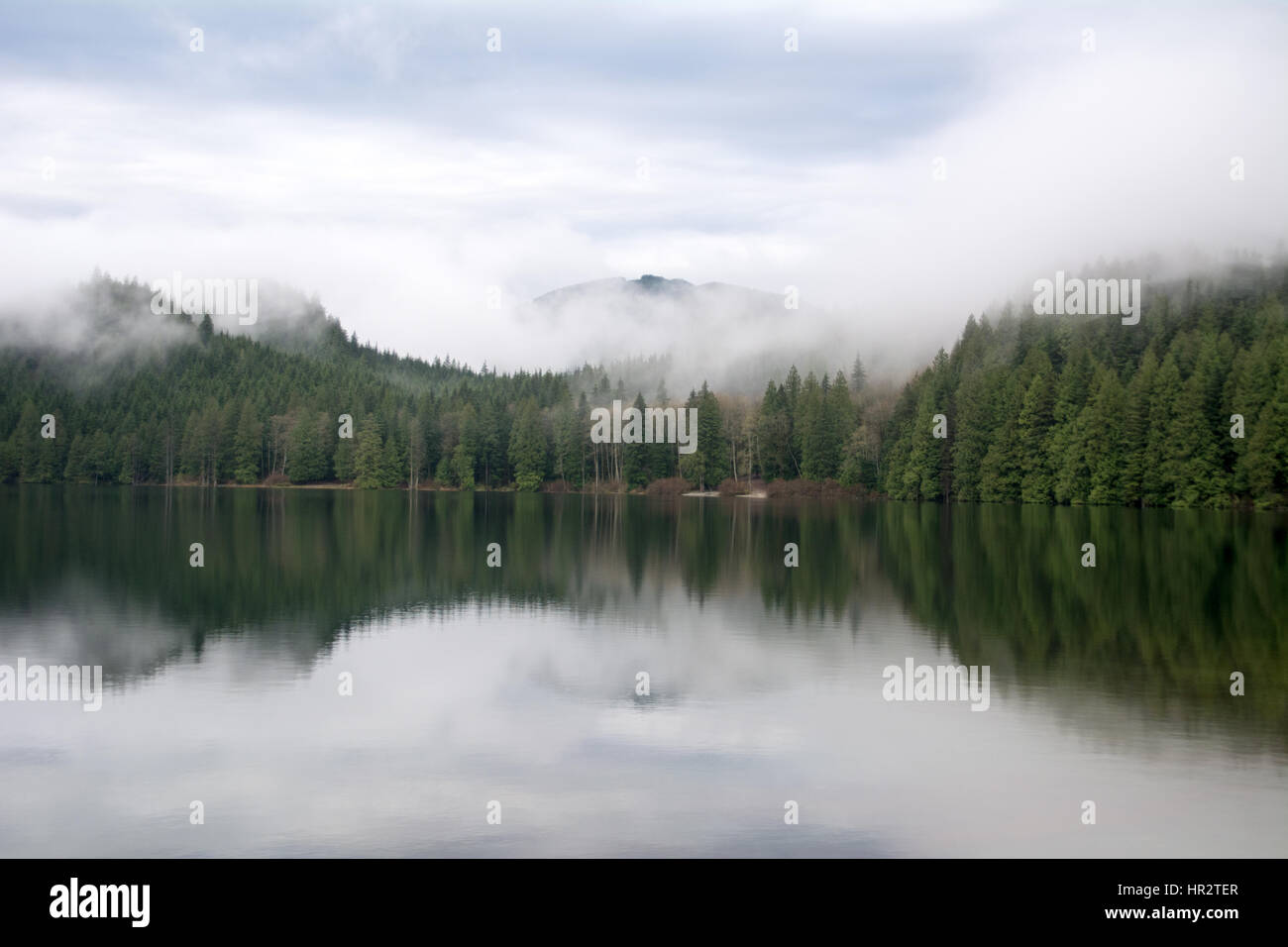 Mist hangs over Davis Lake Provincial Park at dawn, near the town of Mission, British Columbia