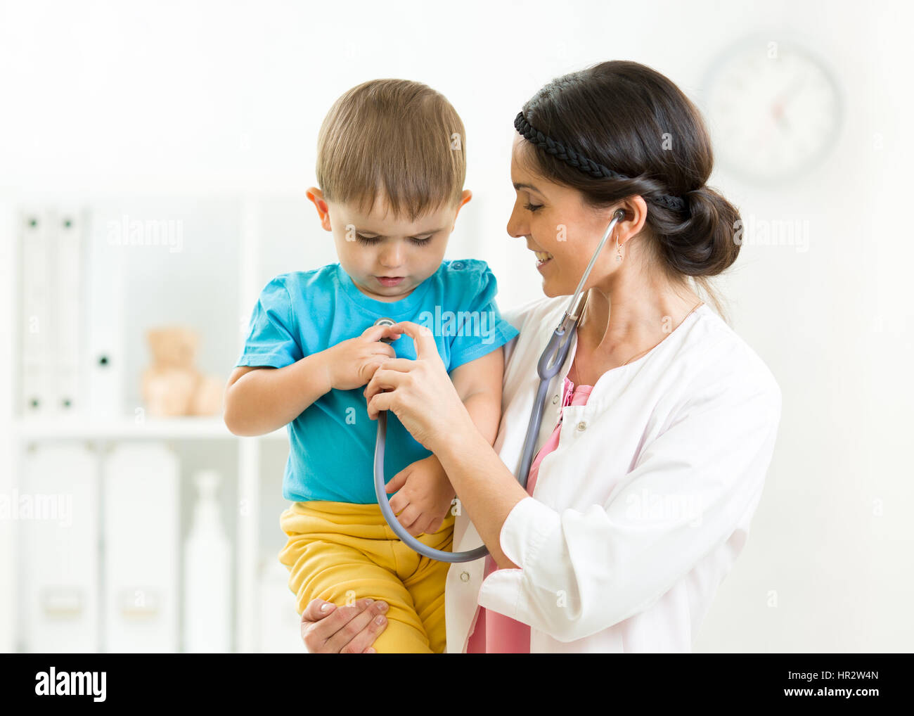 Little boy and young female doctor in hospital having examination Stock Photo