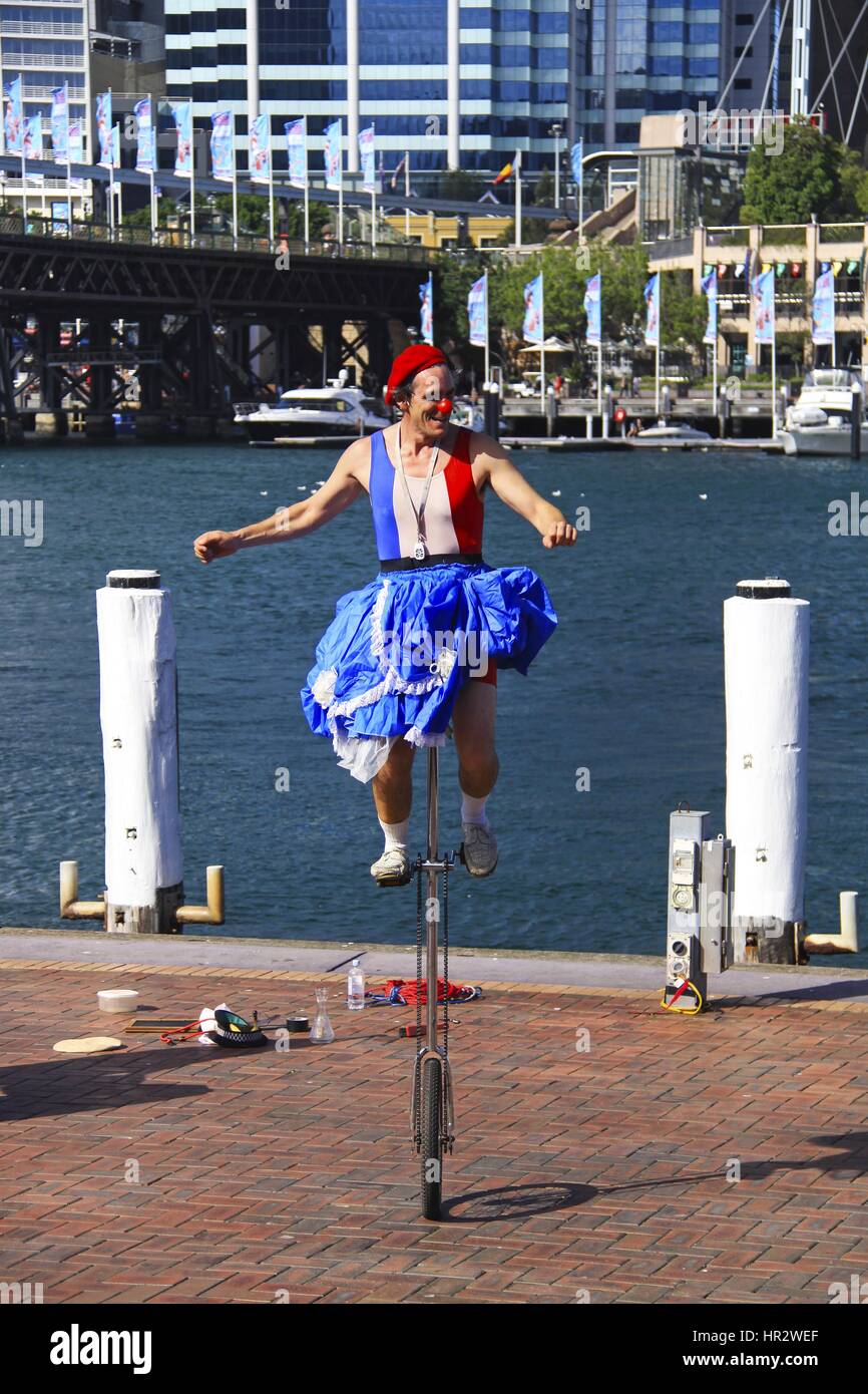 Street Performer balancing on Unicycle  in Harbor of Sydney, Australia Stock Photo
