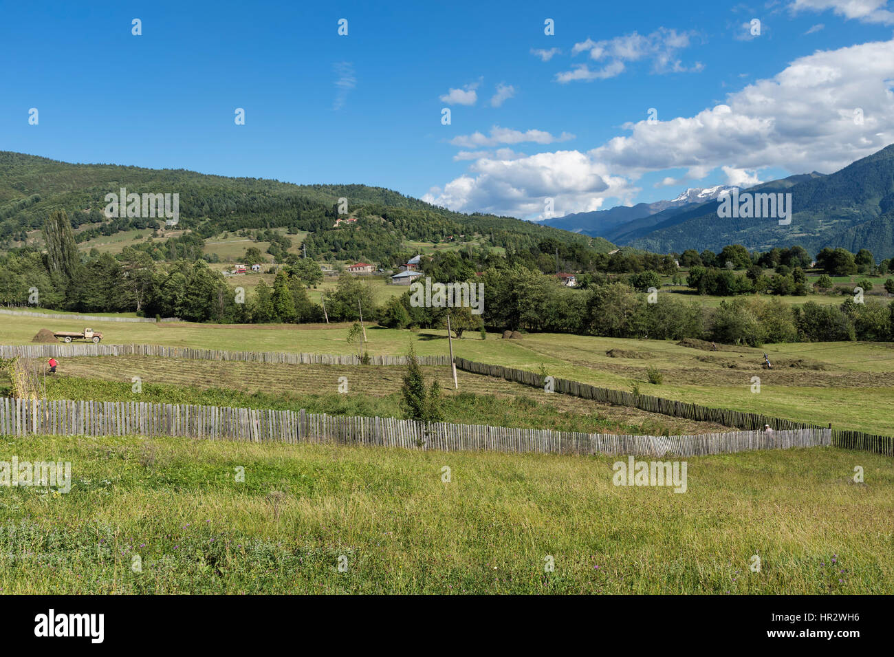 Georgian People working in field, Bucolic scenery, Lashtkhveri, Svaneti region, Georgia, Caucasus, Middle East, Asia Stock Photo