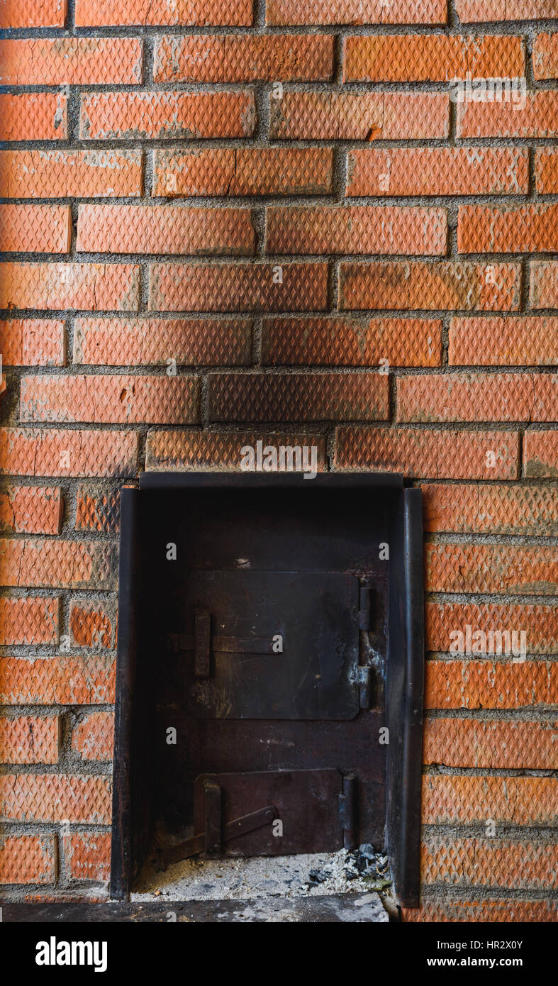 iron stove in the Russian sauna lined with red brick Stock Photo