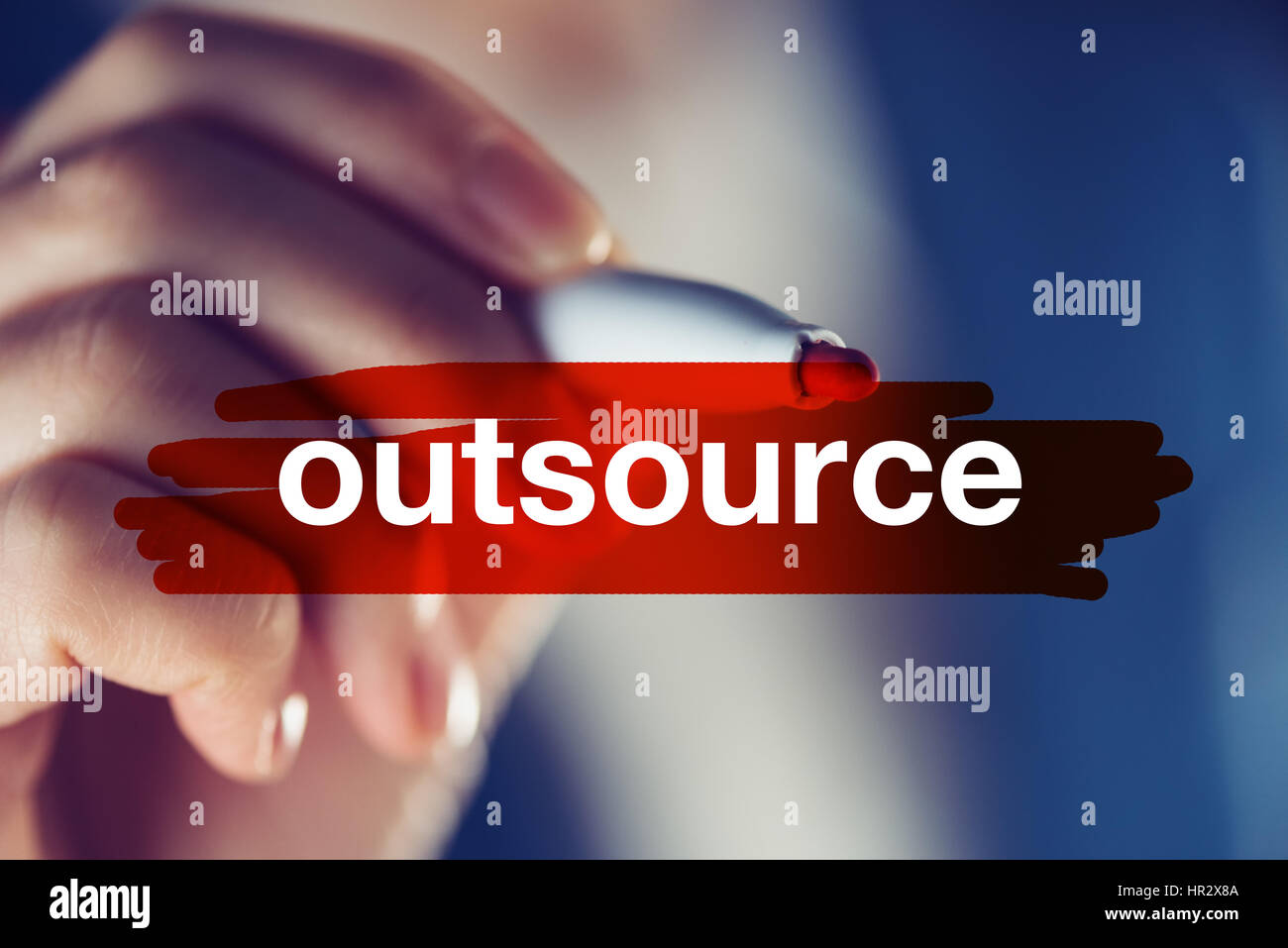 Outsource business concept with businesswoman highlighting word Stock Photo