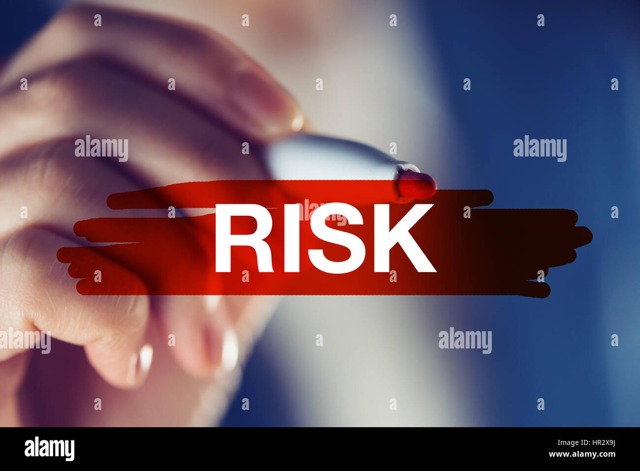 Risk in business concept, businesswoman marking the word with red highlighting marker pen Stock Photo