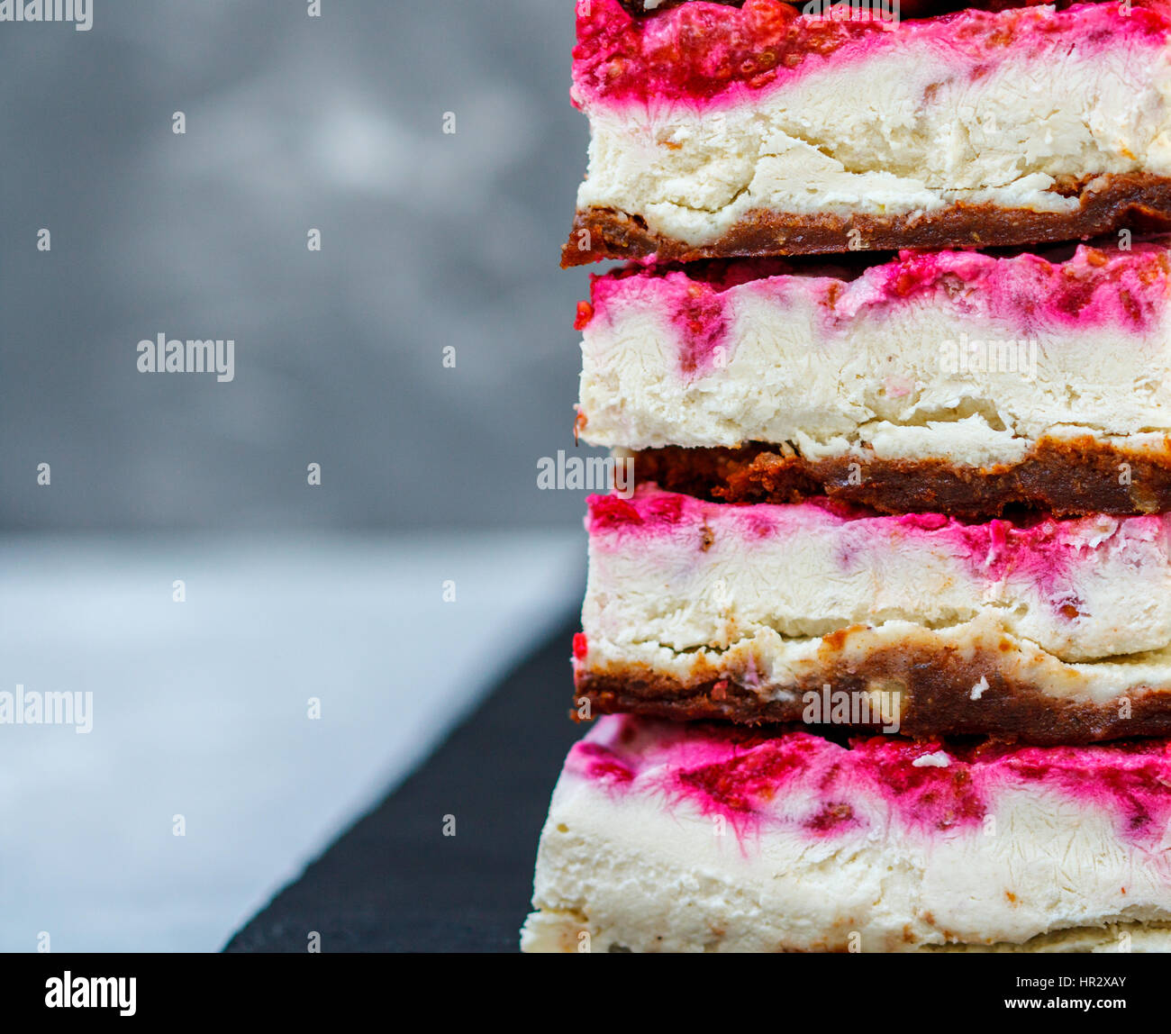 Vegan raw raspberry cheesecake on a dark background. Love for a healthy ...