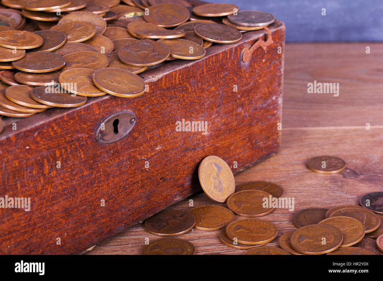 Old wooden chest filled with old copper coins Stock Photo Alamy