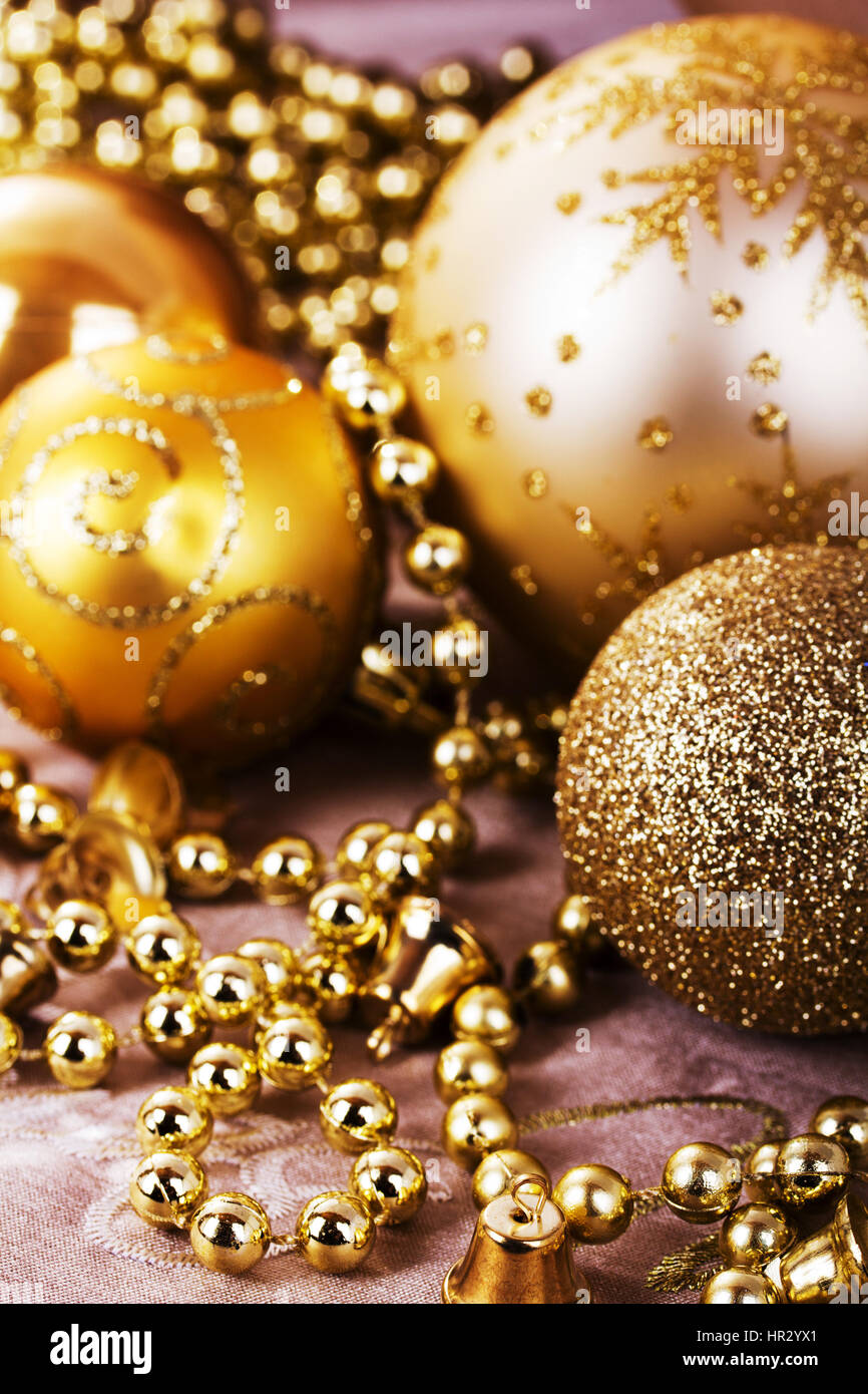 Festive gold Christmas decorations on a fabric background Stock Photo ...