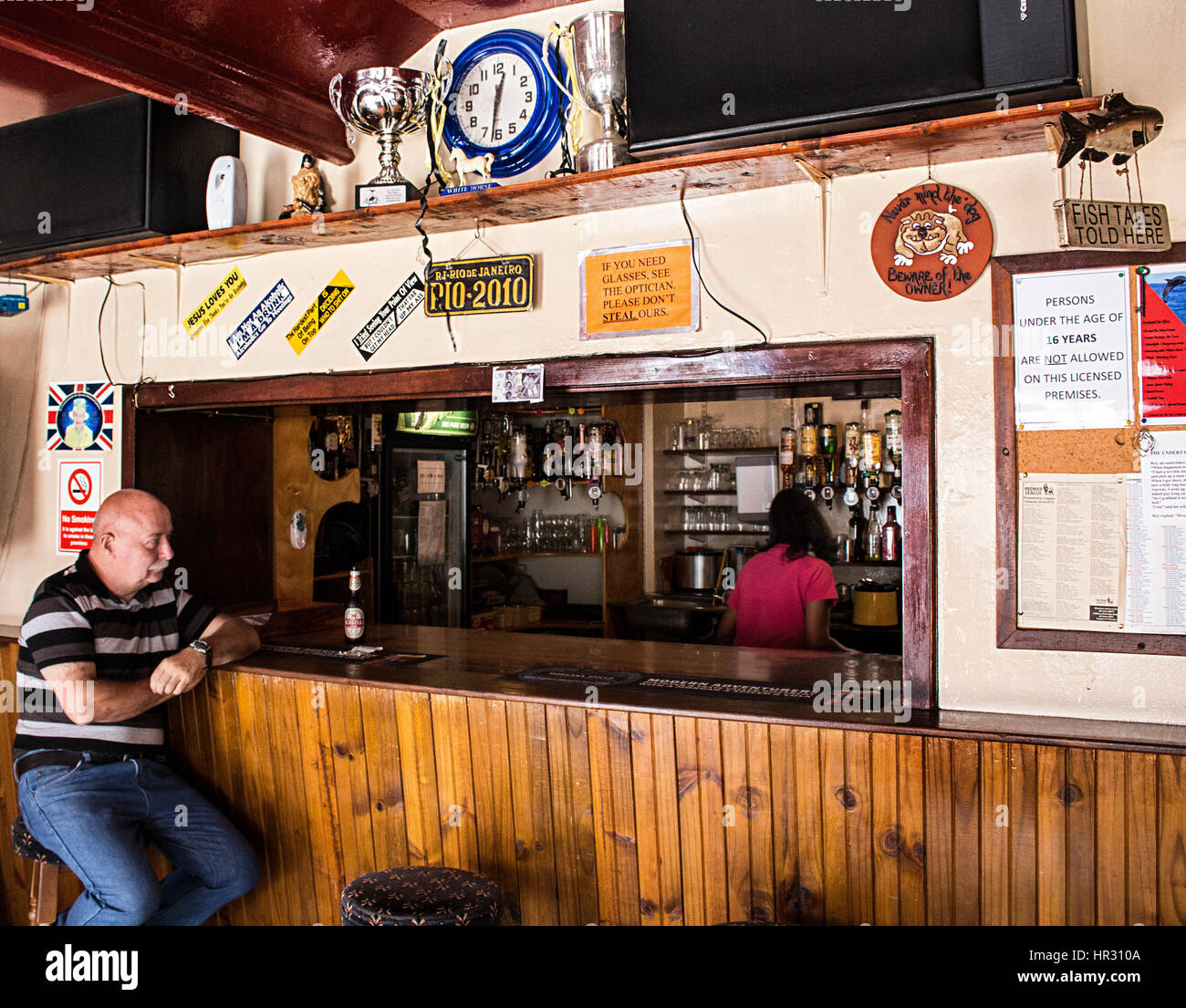 A bald man sitting in a bar in Jamestown, St Helena. Stock Photo