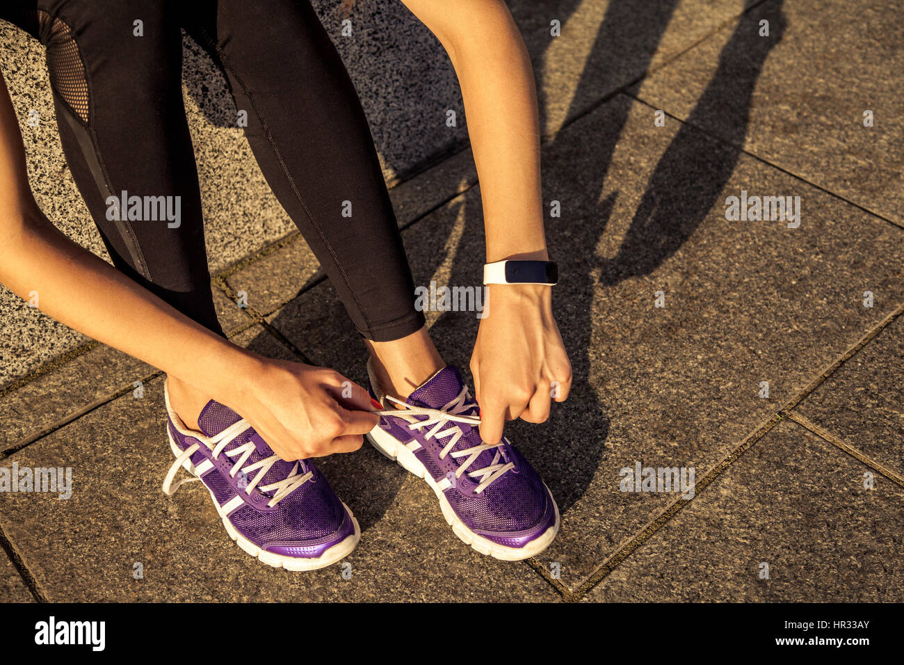 Running shoes. Barefoot running shoes closeup. Female athlete tying laces  for jogging on road in minimalistic barefoot running shoes. Runner getting  Stock Photo - Alamy