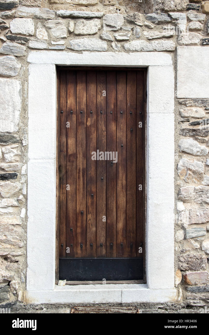Ancient wooden door in old stone wall Stock Photo - Alamy