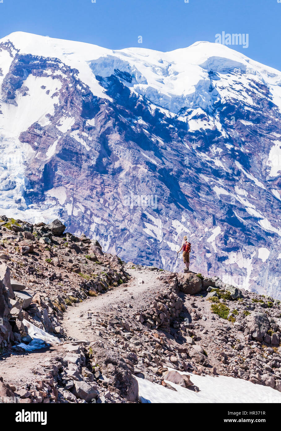 A woman hiking on First Burroughs Mountain below Mount Rainier ...