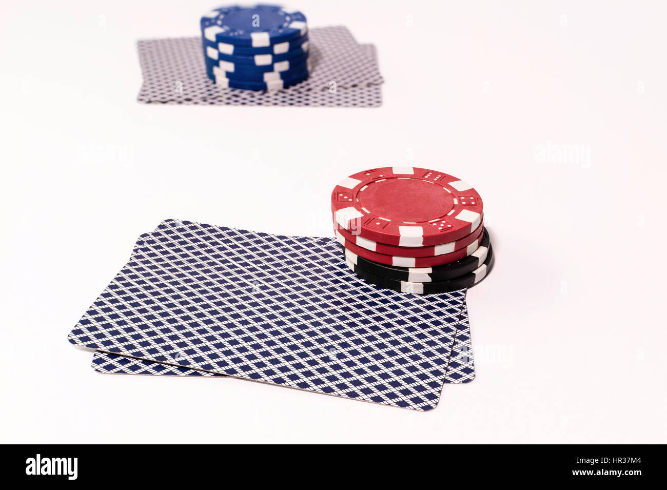 Two hands of Texas Holdem Poker with betting chips Stock Photo