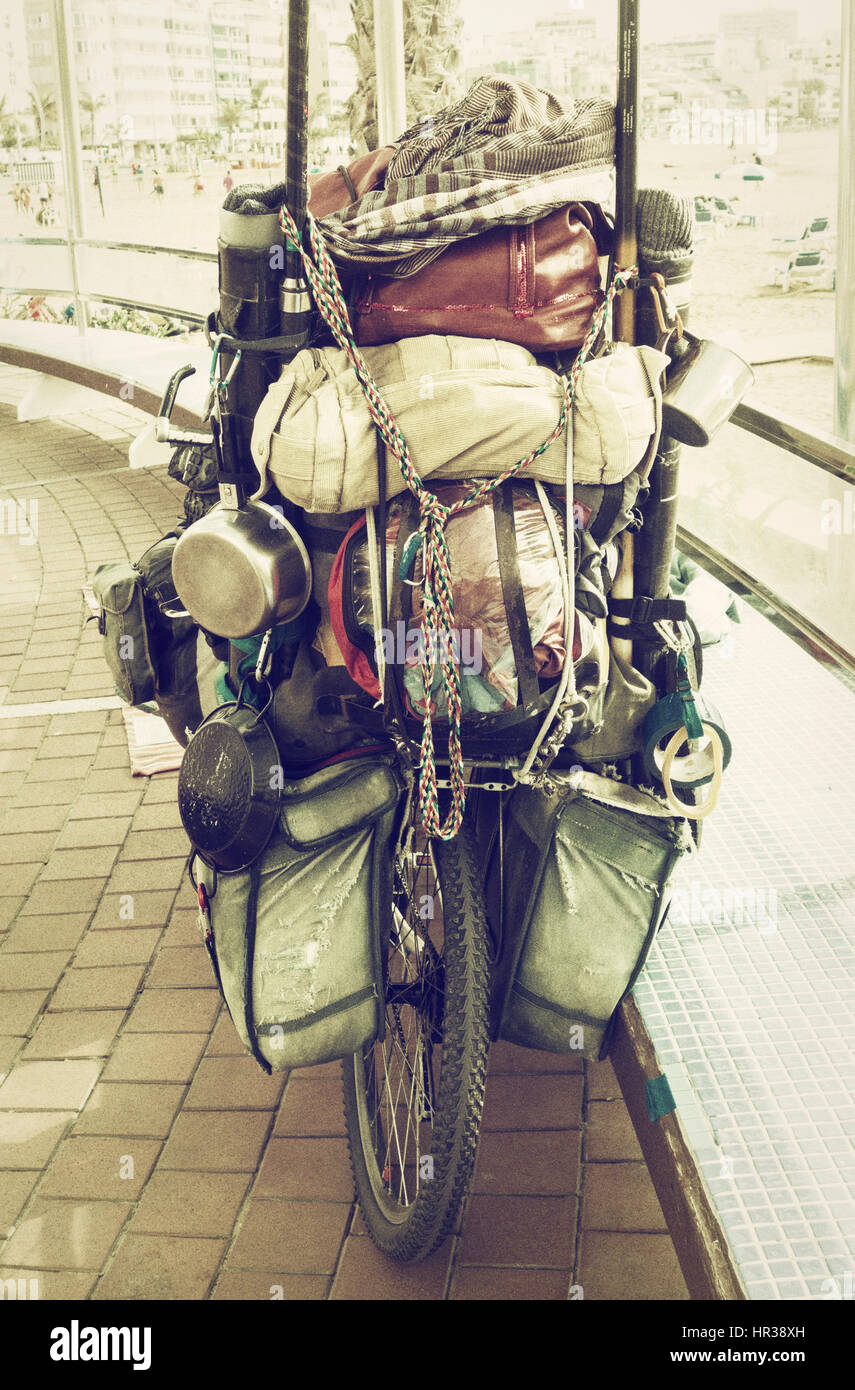Touring bicycle overloaded with panniers and camping equipment Stock