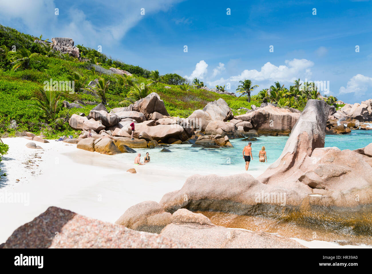 LA DIGUE - AUGUST 10: Tourists enjoying the perfect beach Anse Cocos in La Digue, Seychelles on August 10, 2014 Stock Photo