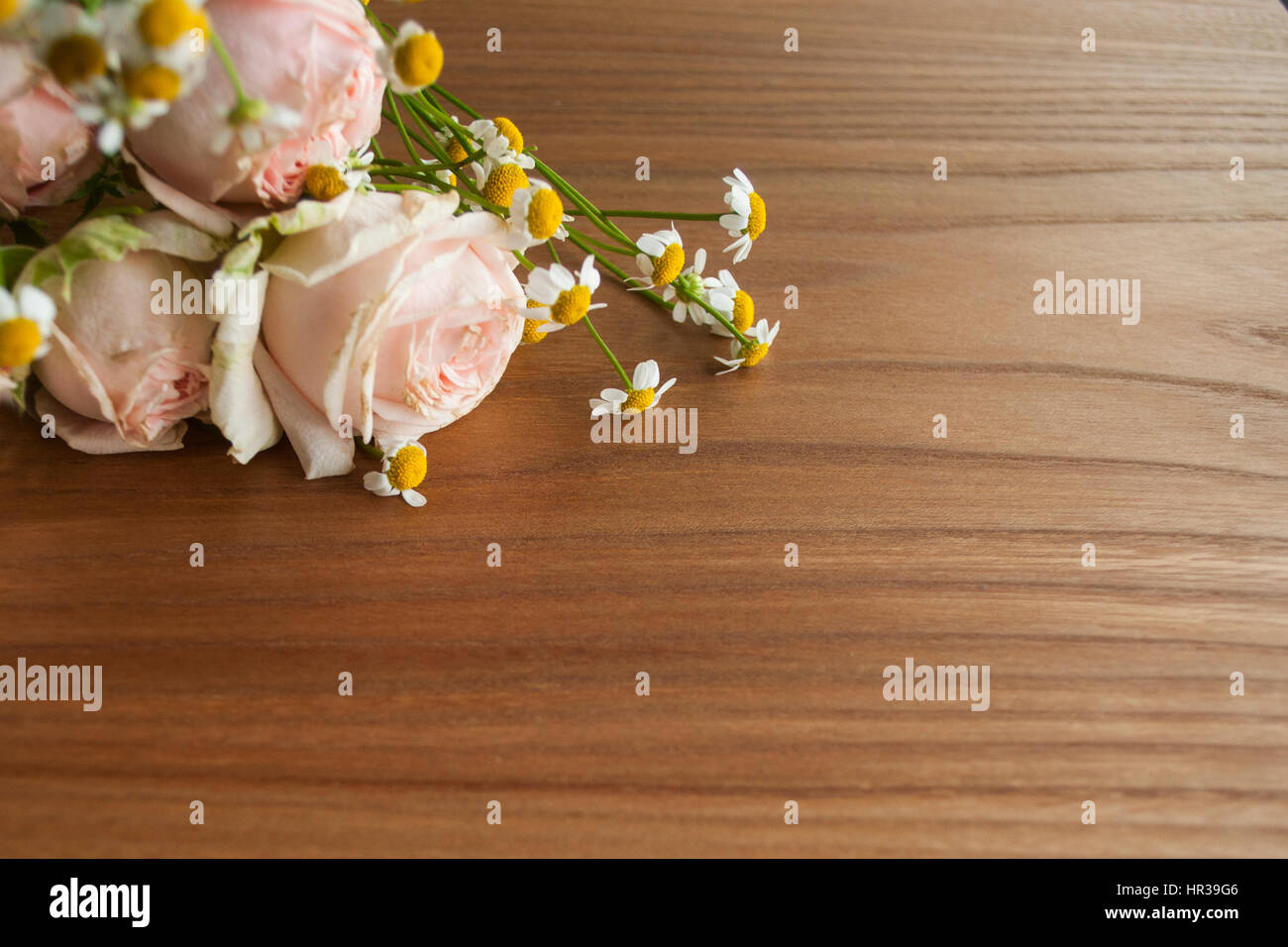 Rose and daisy bouquet on wooden background Stock Photo - Alamy