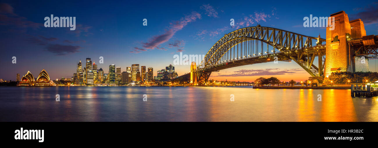 Sydney. Panoramic image of Sydney, Australia with Harbour Bridge during twilight blue hour. Stock Photo