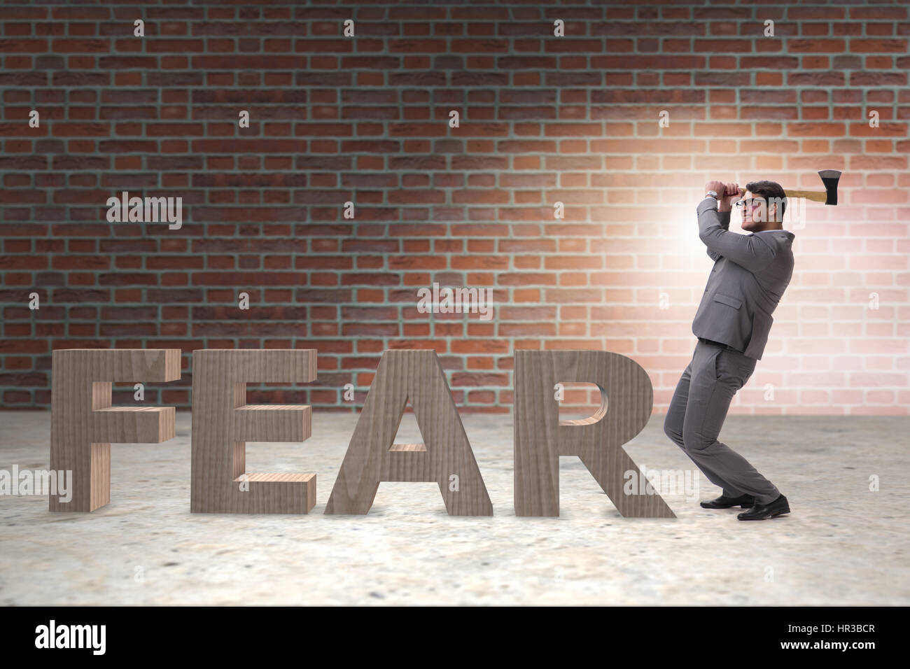 Angry man with axe axing the word fear Stock Photo - Alamy