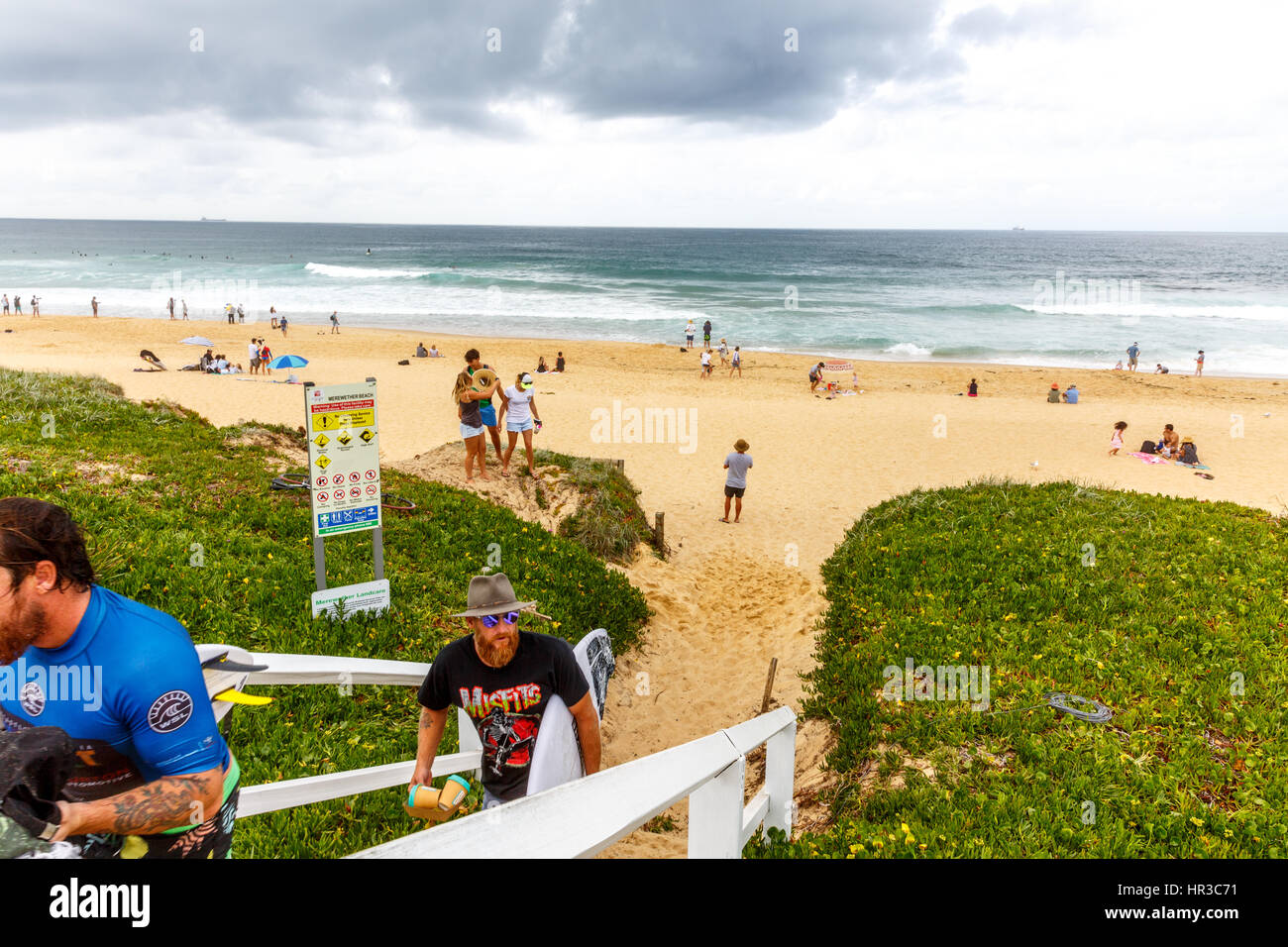 Two surfers leaving Merewether beach in Newcastle,new south wales,australia Stock Photo