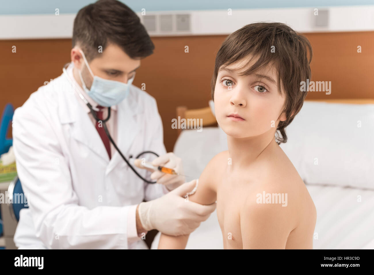 Doctor examining bare chested child with stethoscope Stock Photo - Alamy