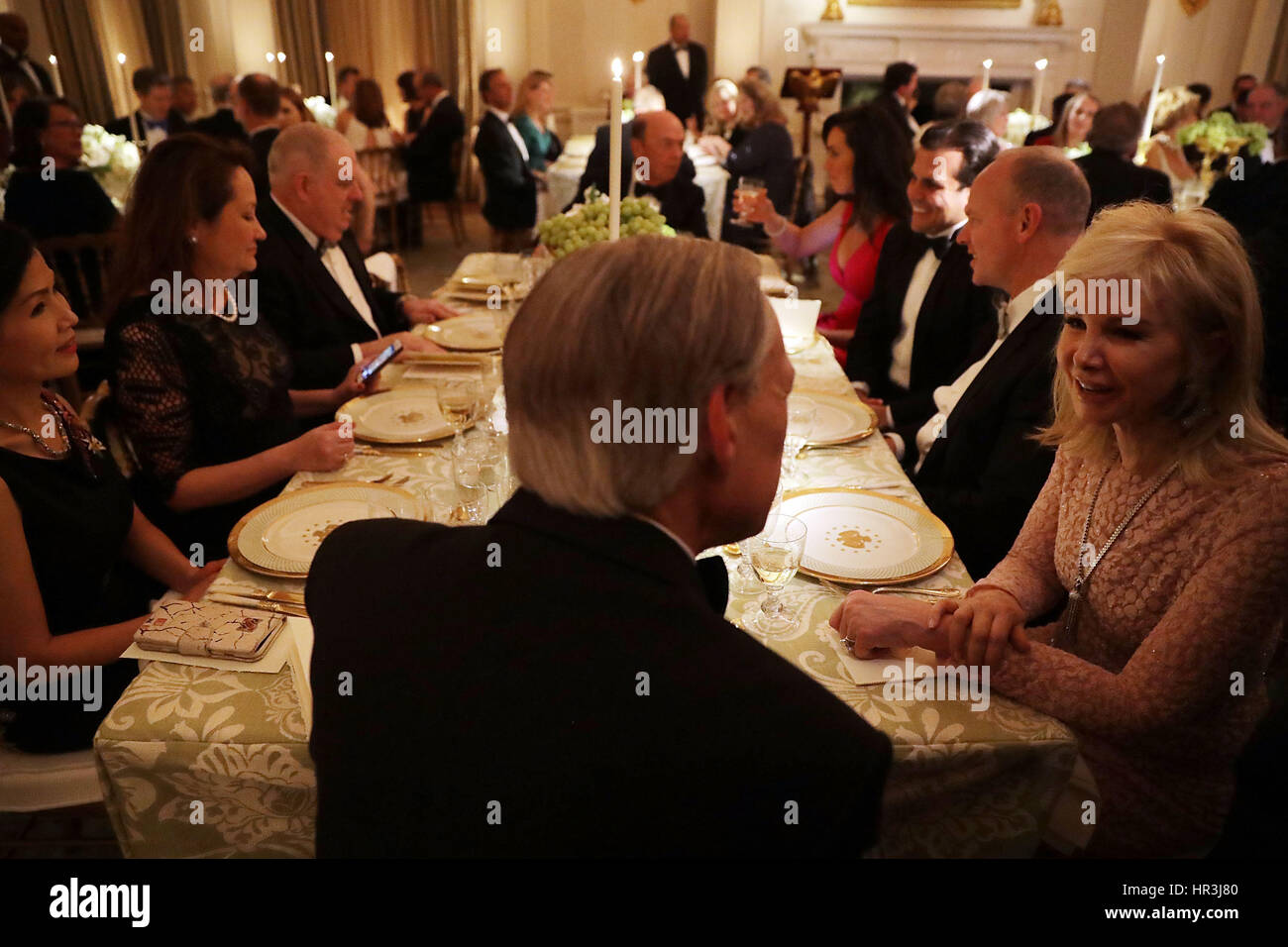Washington DC, USA. 26th February 2017. Texas Governor Greg Abbott (back to camera), Maryland Governor Larry Hogan and other sit together during the annual Governors Dinner in the East Room of the White House February 26, 2017 in Washington, DC. Part of the National Governors Association's annual meeting in the nation's capital, the black tie dinner and ball is the first formal event the Trumps will host at the White House since moving in last month. Credit: Chip Somodevilla/Pool via CNP /MediaPunch/Alamy Live News Stock Photo