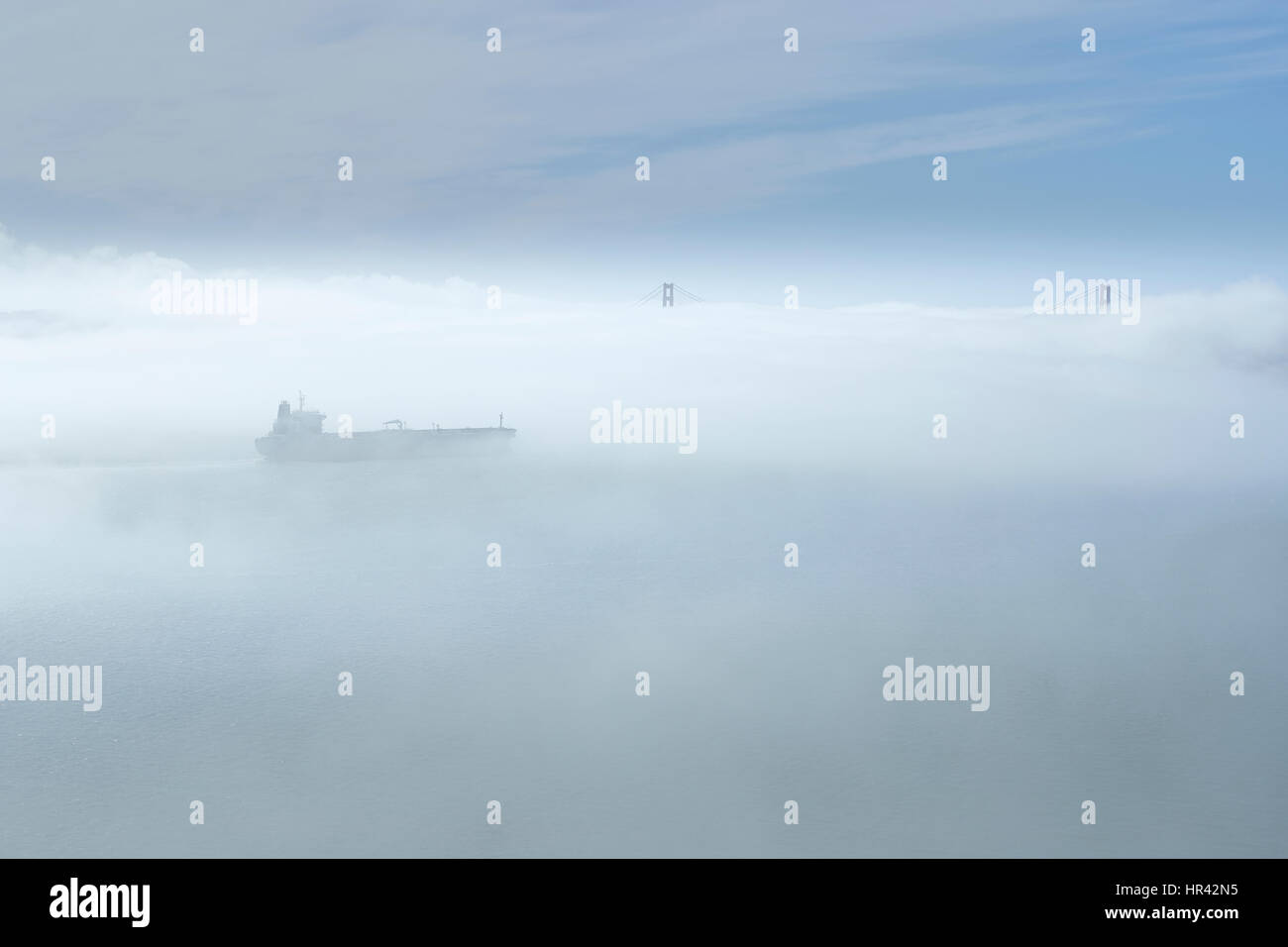 Cargo Ship Leaving San Francisco In Thick Fog, California, USA Stock Photo