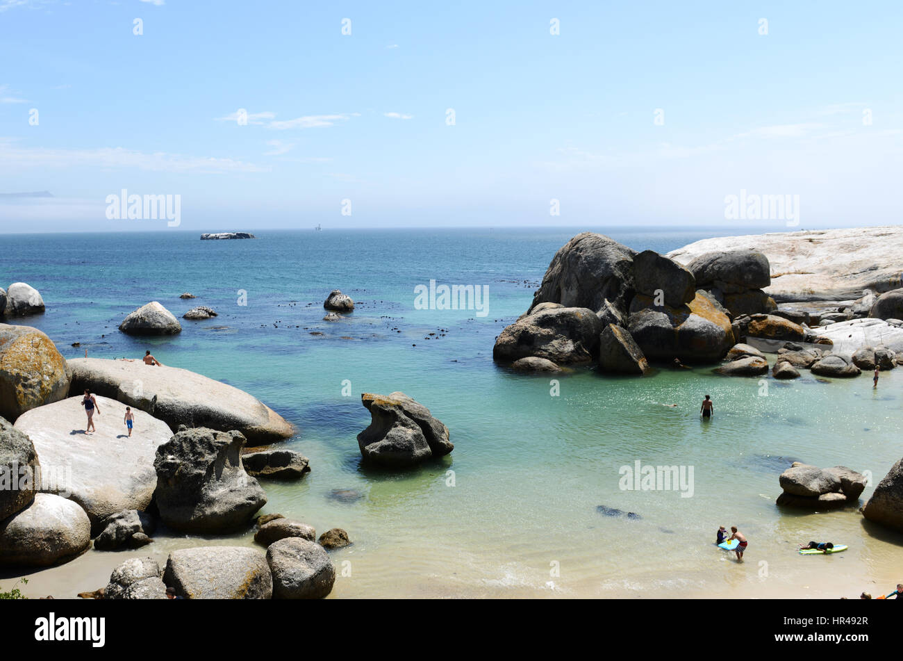 Visitors soaking up the sun on the sandy Boulders beach in the Cape Peninsula in South Africa. Stock Photo