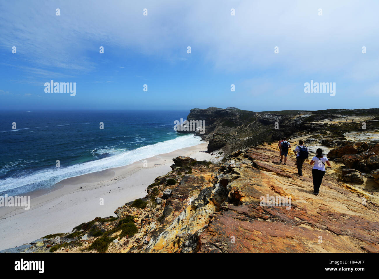 Hikers hiking above Dias beach in the Table Mountain national park, near the cape of good hope. Stock Photo