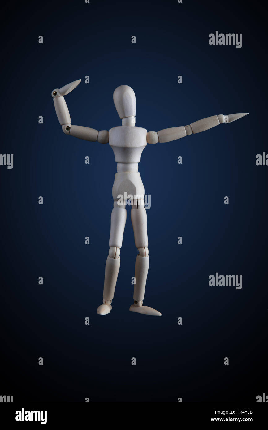 Wooden figurine flexing muscles in bodybuilder pose on dark background Stock Photo