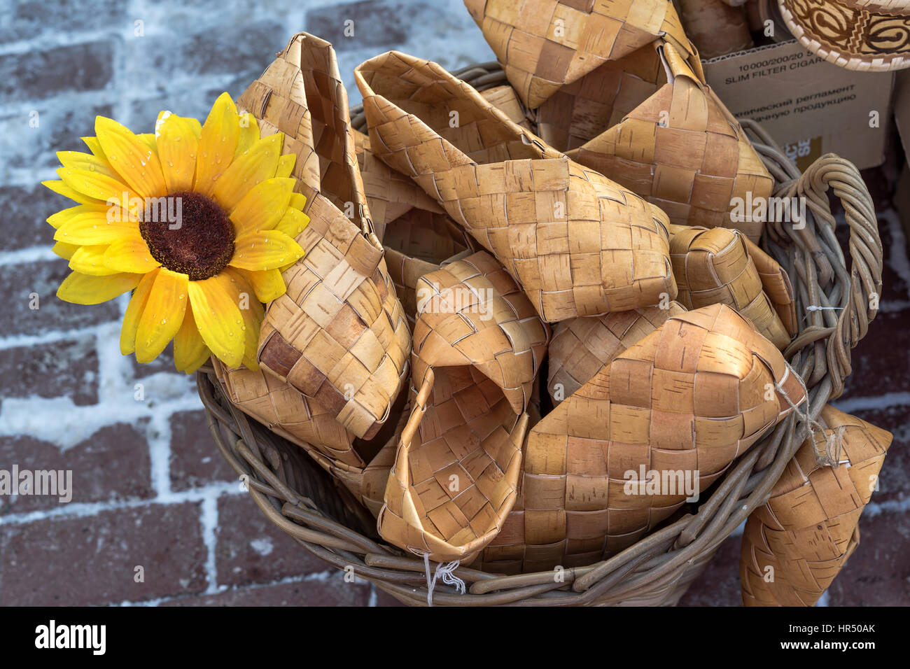 Wicker birch bark bast shoes in a basket at the fair Stock Photo Alamy