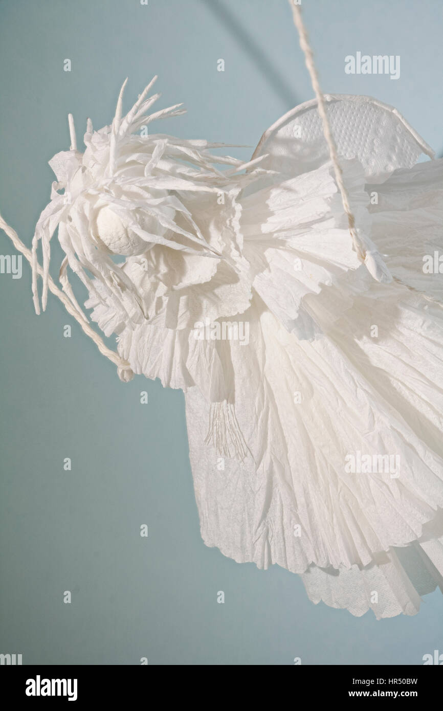 white winged  paper puppet angel on swing close to Stock Photo