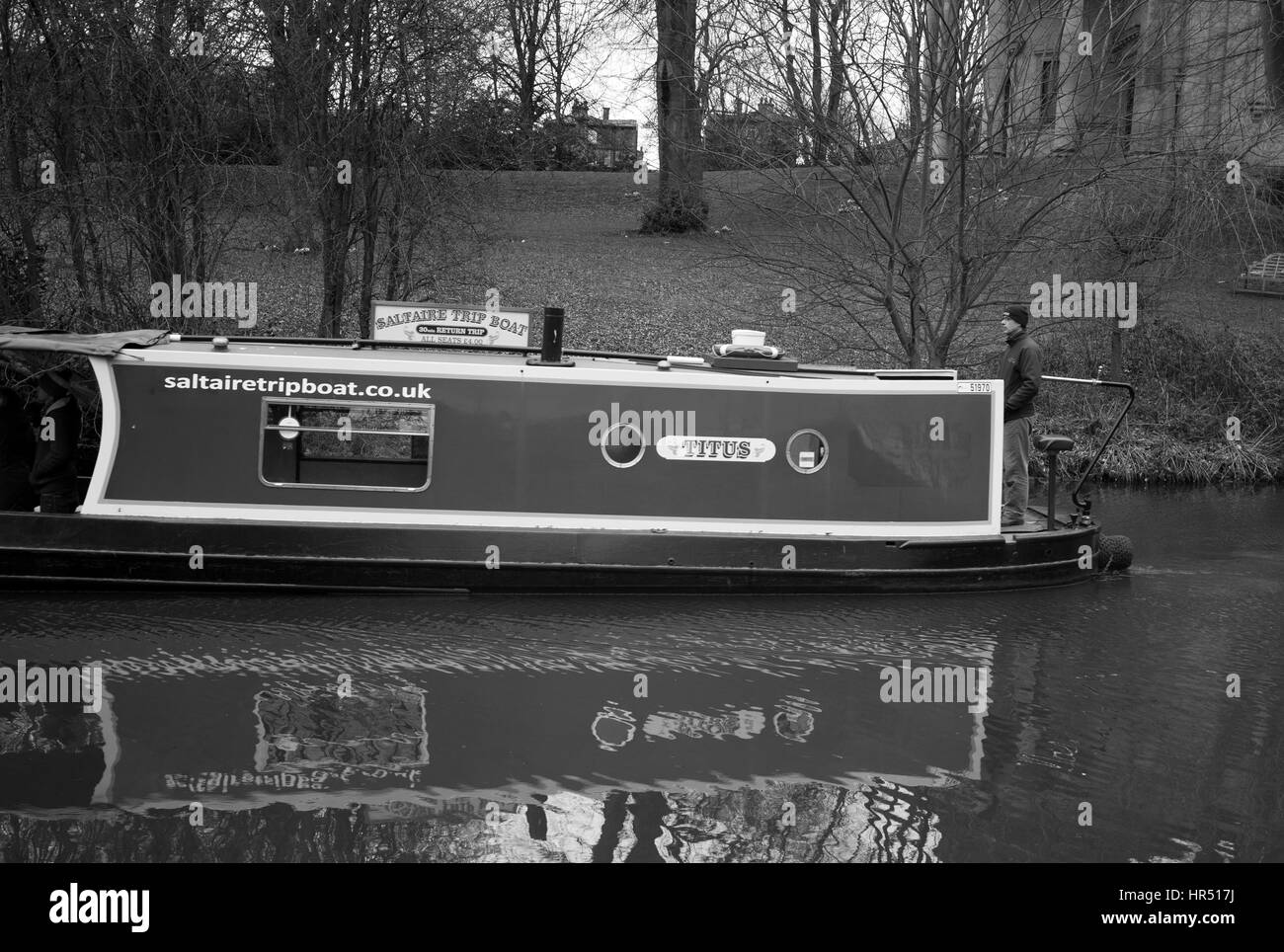 Tourist barge on canal next to Salt's Mill, Saltaire, Bradford, West Yorkshire Stock Photo