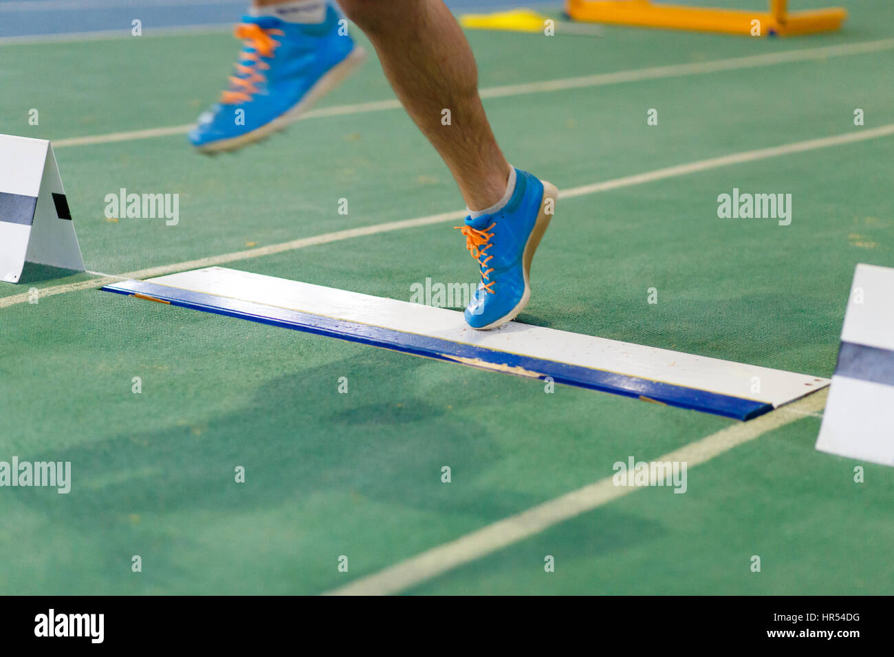 Sportsman landing his leg on board before taking off in long jump or