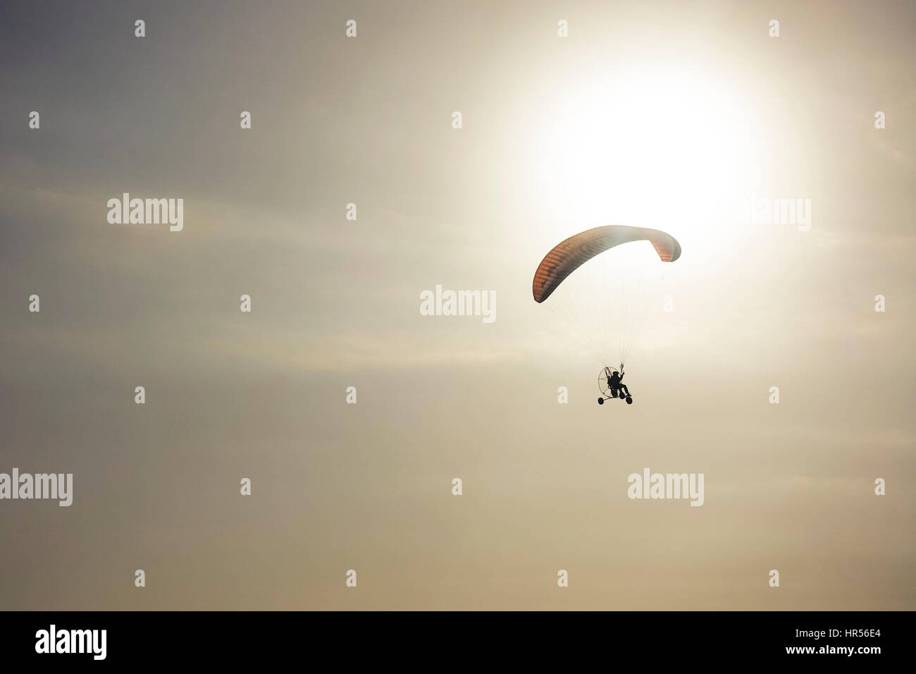 Powered paragliding,  paramotoring, Powered paraglider. during sunset, Spain. Stock Photo