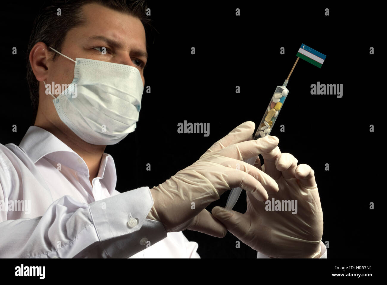 Usman Injection Young man as a doctor gives a medical injection to Uzbekistan flag on a ...